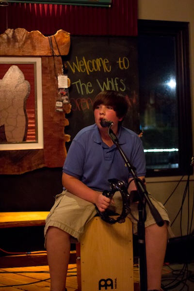 Benjamin Schick plays his tambourine on stage.