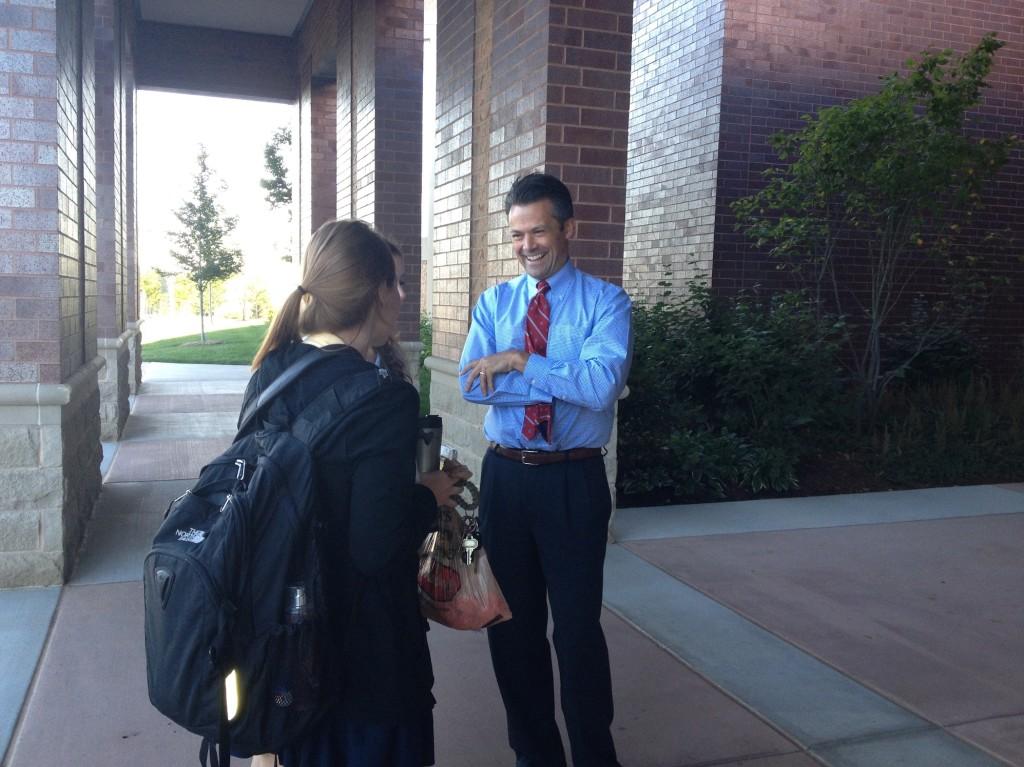 Dr. Tom Stoner, head of school, greets students in the morning as they walk into school.