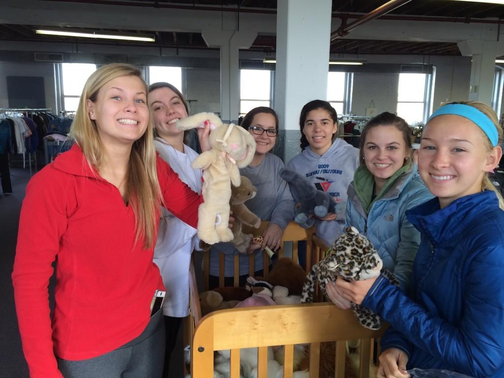 Swimmers Olivia Coomes, junior, Lucy Kehr, sophomore, Clara Gruniesen, sophomore, Mackenzie Weiberg, freshman, Izzy Haupfer, sophomore, and SJ Fiala, junior, pose with adorable stuffed animals for the children.