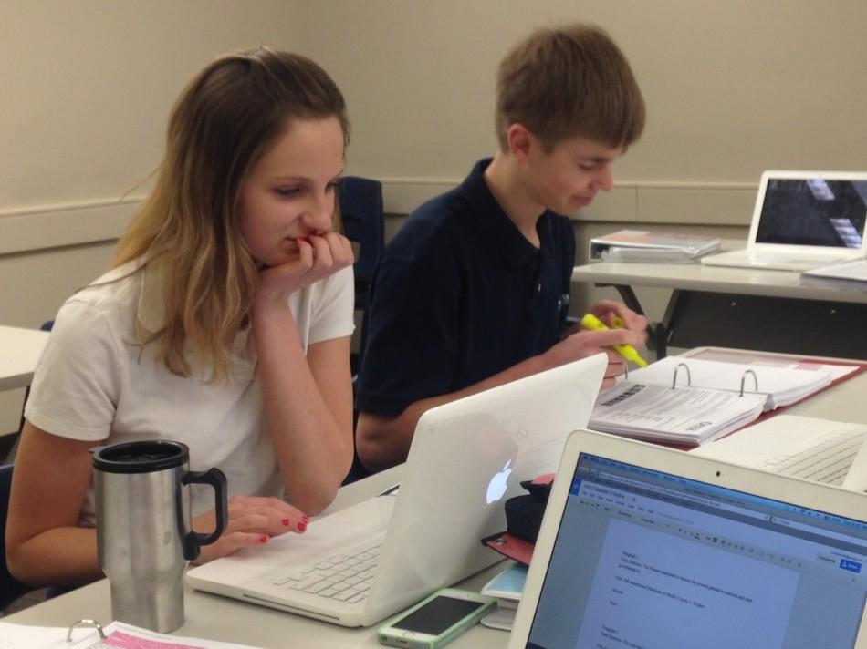 Julia Alpert and Chad Maxey, seniors, work diligently during class, conducting research for their papers.