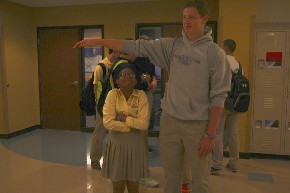 Kayla Wilson, junior, stands under Brendan Bognar, junior’s, outstretched arm with room to spare, exagerating their height difference.