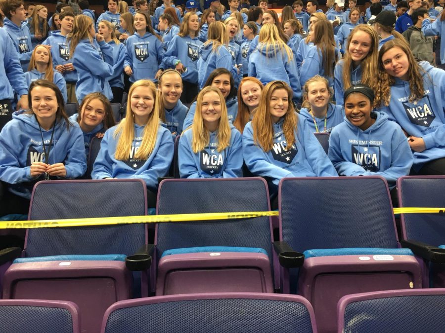 The 2018 girls soccer team sits with the Blue Crew at the Wickenheiser Cup game two seasons ago. 