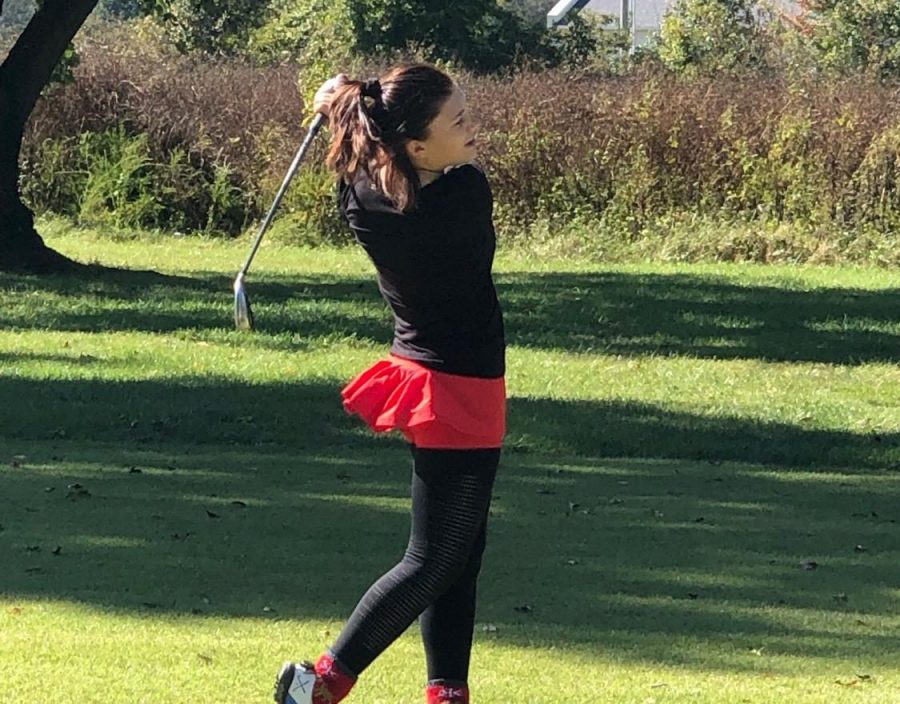 Ellie Johnson follows through after teeing off during a match.