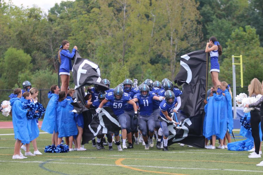 The Wildcats run out through the banner before their game against Lutheran North.