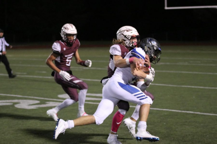 Ben Straub is brought down by a Warrior defender after a long gain in a game against St. Charles West on Oct. 25, 2019.