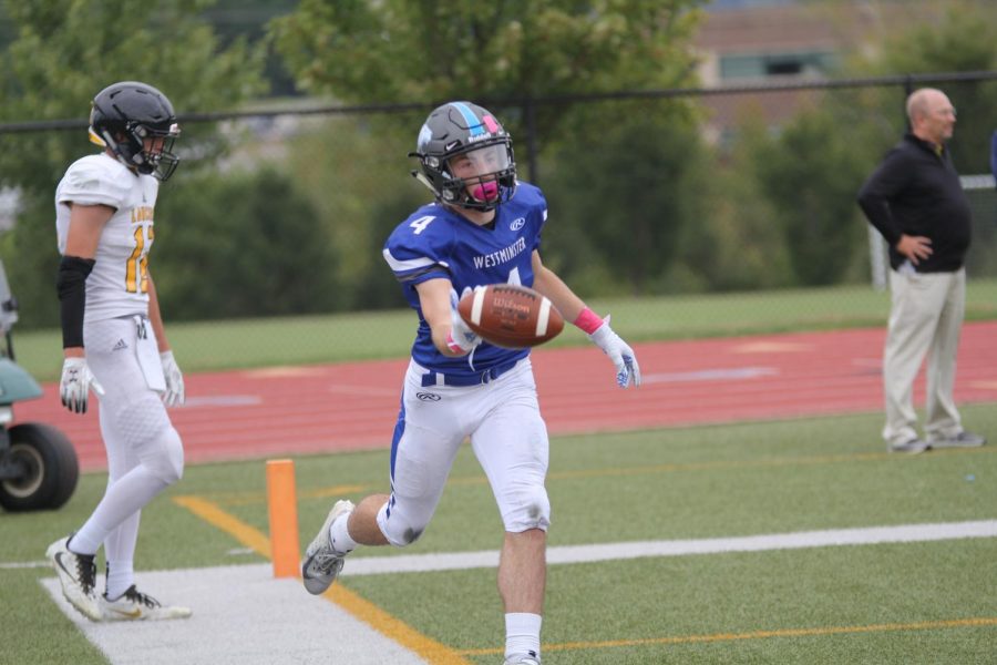 Ben Hicks tosses the ball to the referee after a long touchdown against Lutheran South. 