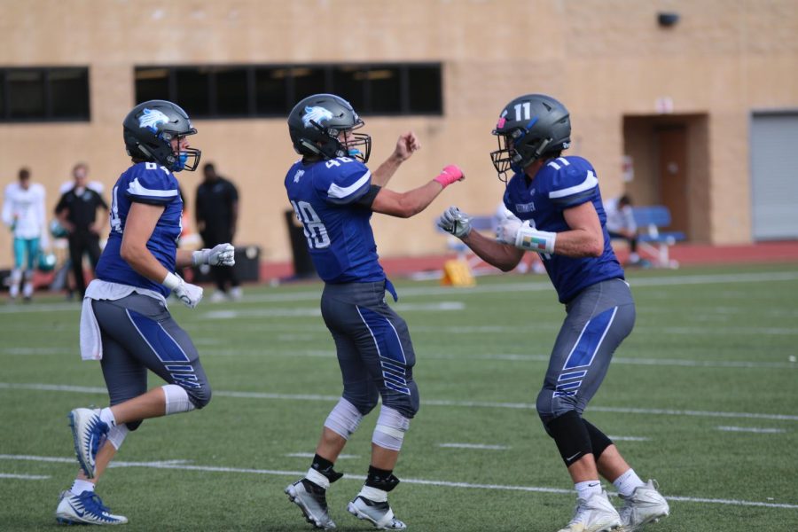 Sophomore Nolan Jones celebrates after running for a touchdown to seal the victory against Christian High.