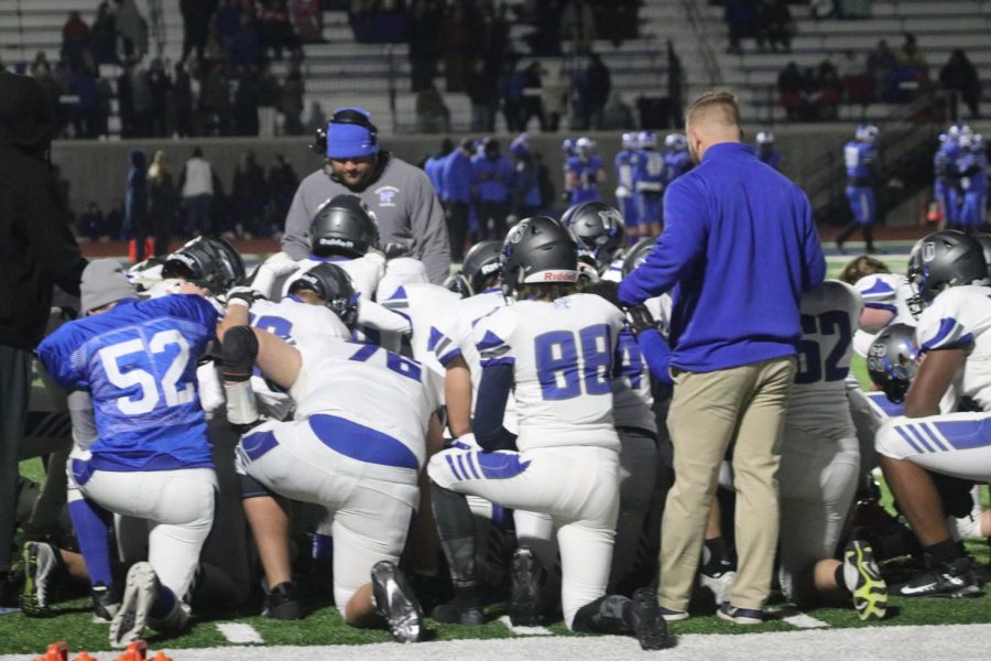 The Wildcats kneel in prayer after linebacker Arthur Jordan went down with a serious injury in the third quarter of the District Semifinal against Ladue.