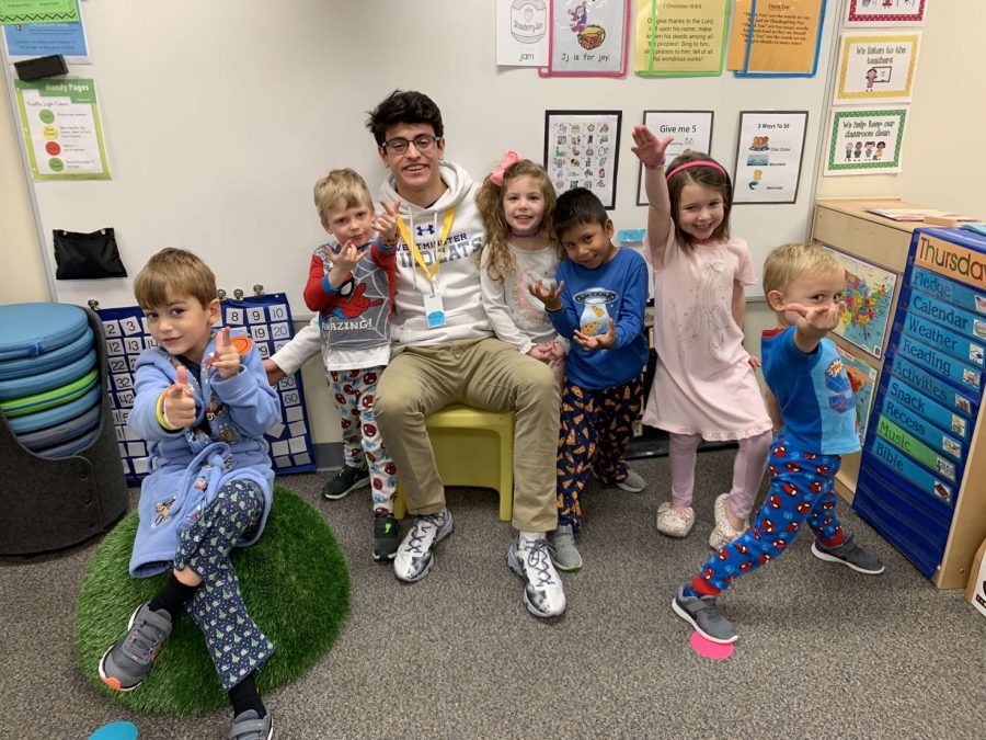 Senior Sebastian Lacassie serves a junior kindergarten class every Thursday morning at Kirk.