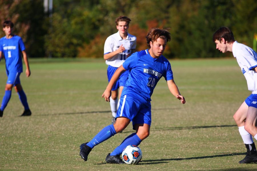 Senior+Will+Mason+dribbles+the+ball+on+Senior+Night+against+Duchesne+High+School.