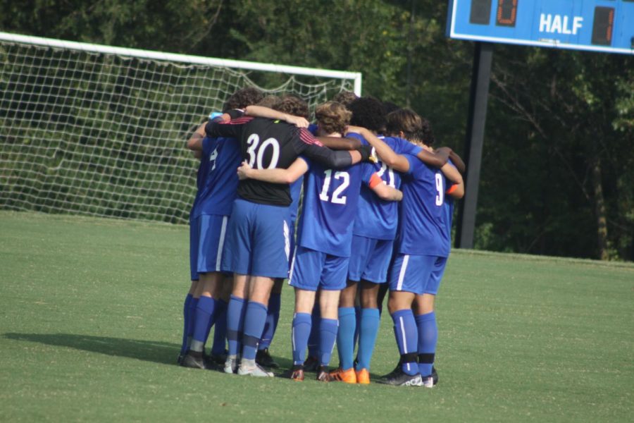 The team huddles to pray before the start of a regular season match.