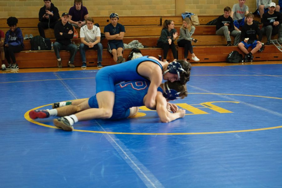 Junior Hayden Turley pins his opponent during a match at John Burroughs.