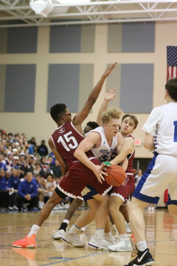 Brennan Orf fights through a double team in the first half against MICDS on January 10th.