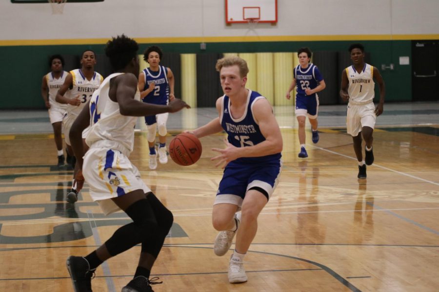 Brennan Orf drives the ball in transition. On this play, he would reach 1,000 career points.