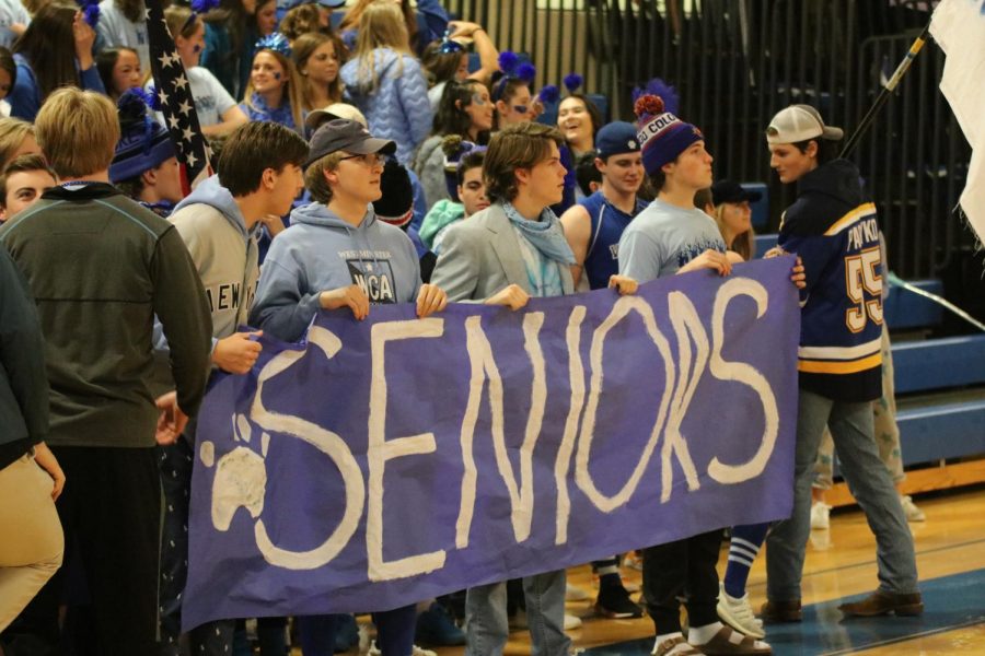 The+Seniors+stand+with+their+banner+on+Day+One+of+Spirit+Week.