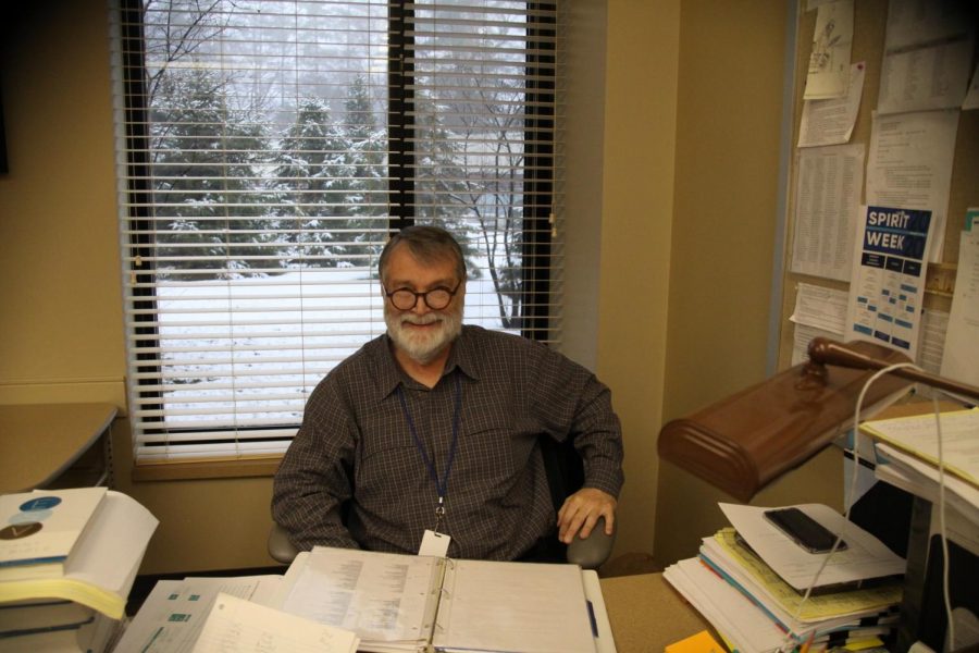 Hughes poses for a picture in his classroom. Photo by: Maggie Lindstrom