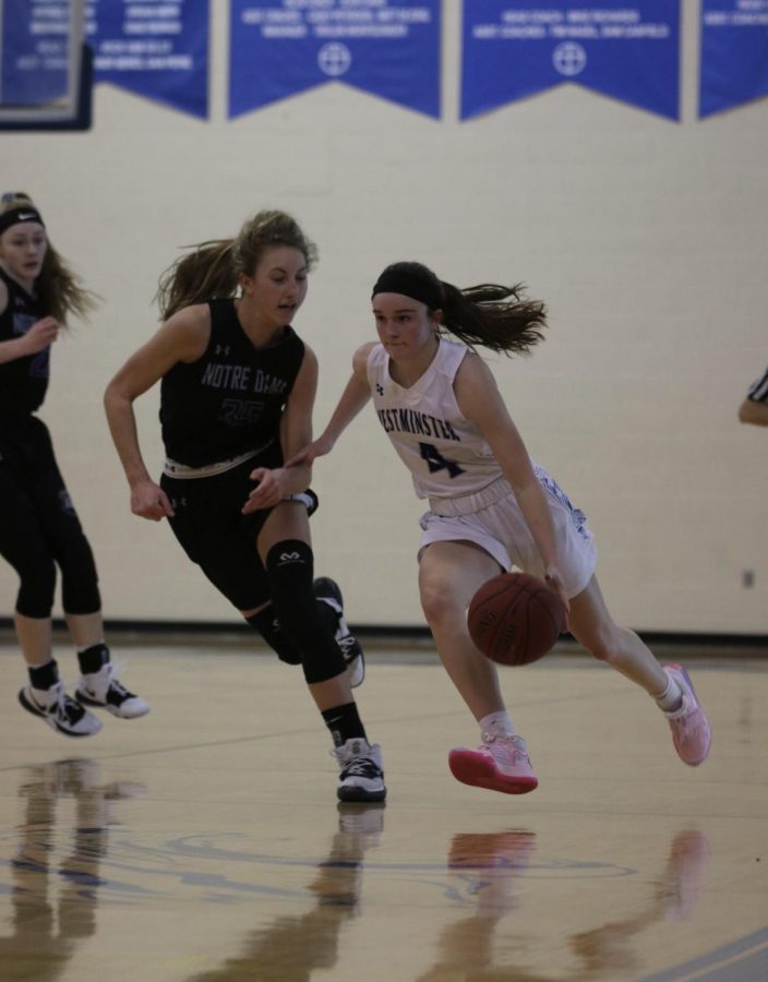 Sophomore Brooke Highmark pushes the ball down the floor against the press.