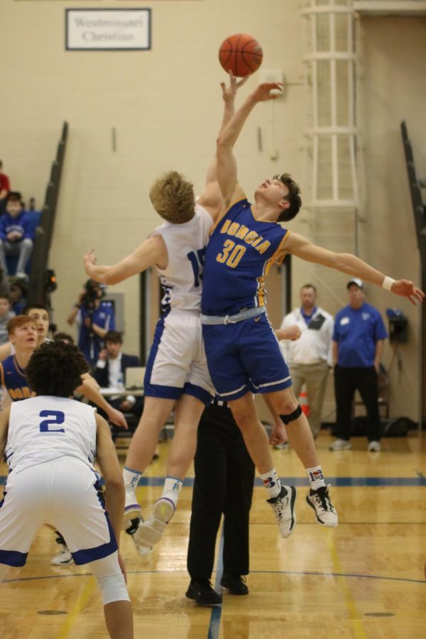 Brennan Orf takes the tipoff in the District Semifinal against Borgia.