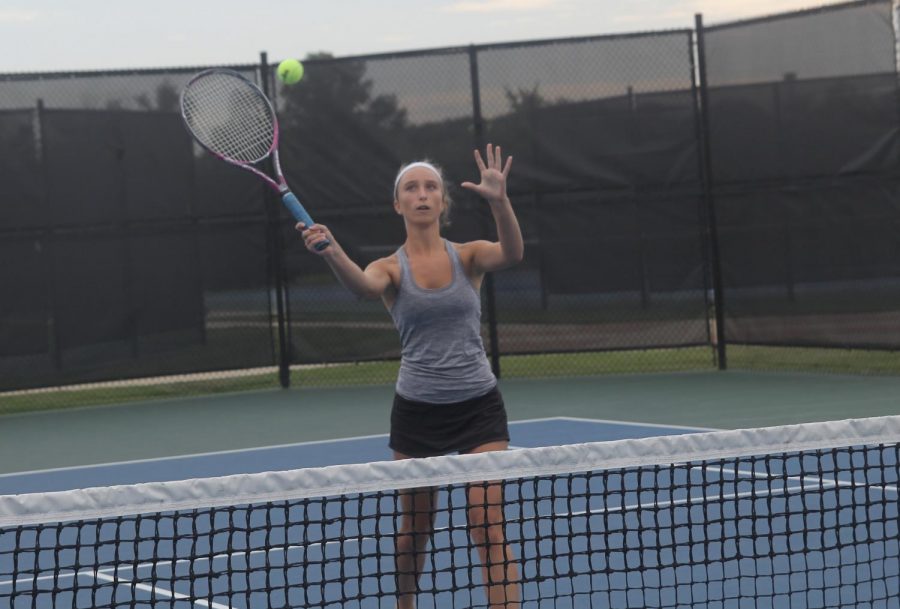 Alexis Hackmann, freshman, hits the ball over the net.