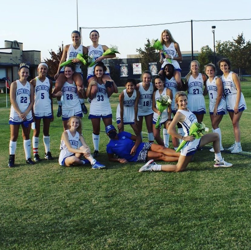 The field hockey players celebrate Grace Clement, Ellie Callier, and Abby Sickels on senior night.