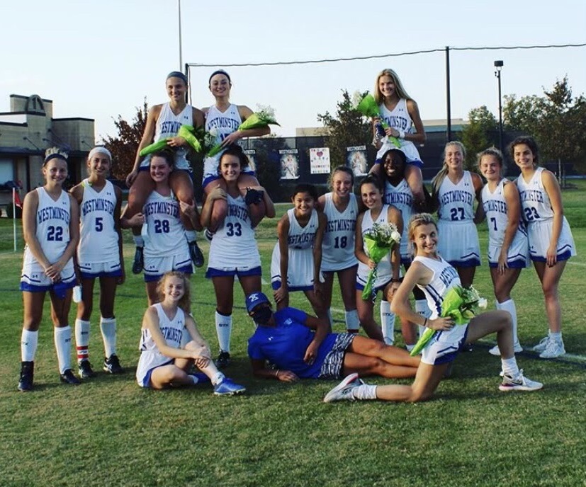 The field hockey players celebrate Grace Clement, Ellie Callier, and Abby Sickels on senior night.