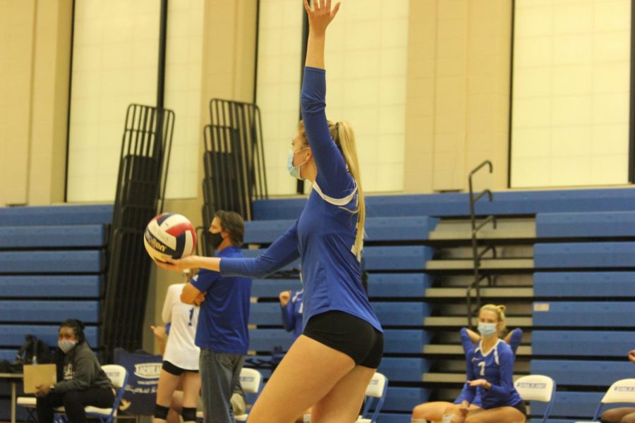 Alli Bishop tosses the ball up to serve against Ladue.