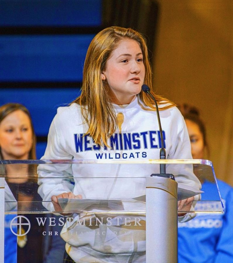 Kaitlyn+Mann%2C+the+sophomore+class+president+speaking+in+chapel+of+2019-2020+school+year.