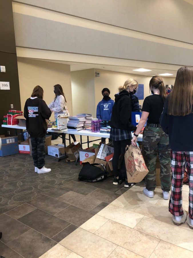 The sophomore table on the last day of ITSOG, packed with school supplies and volunteers. 