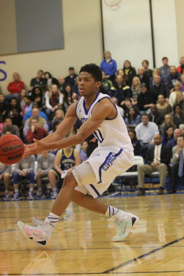 Cook shuffle passes to a teammate in a game against John Burroughs.