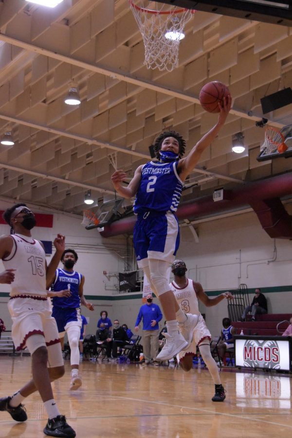 EJ Williams scoops in a left handed layup on a fast break.