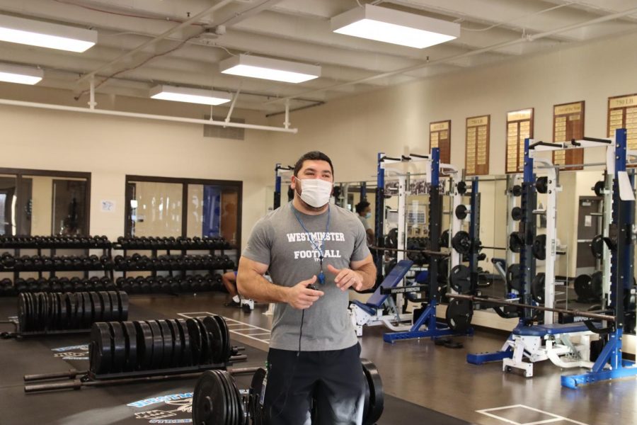 Coach Schoenberg instructs athletes in the weight room.