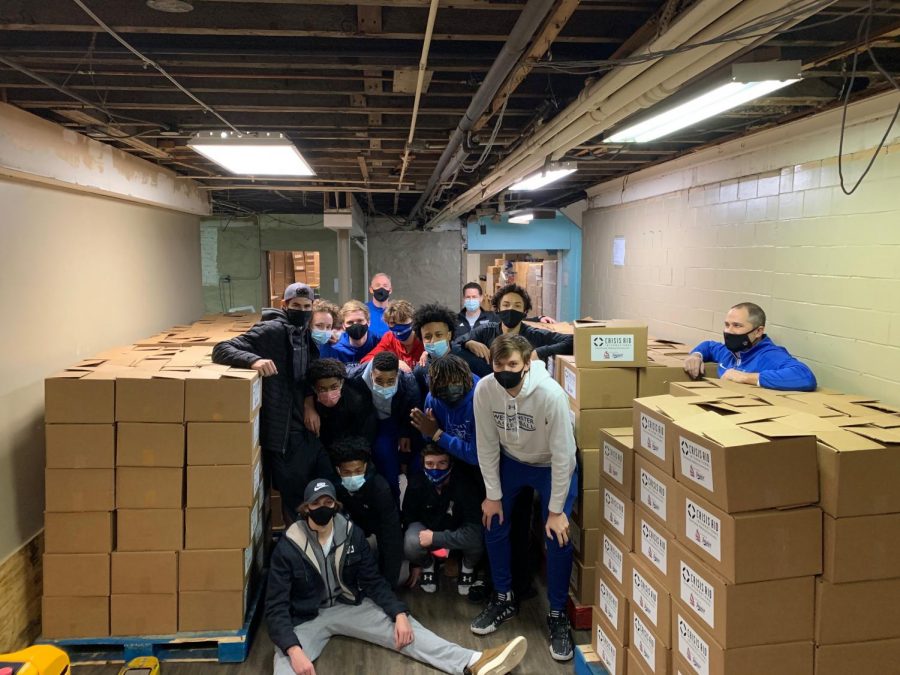 The boys varsity basketball team serves with Crisis Aid International.