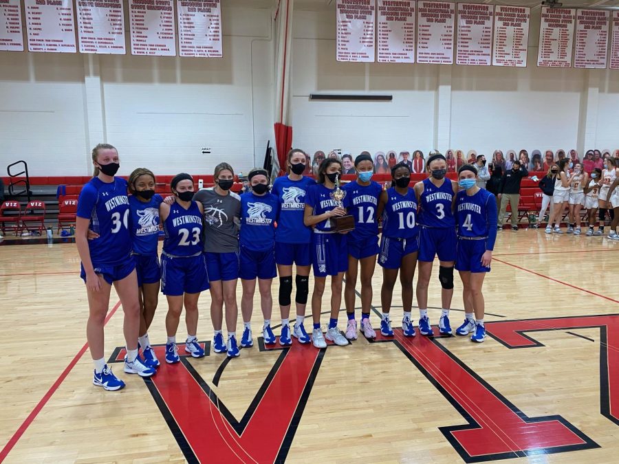 The girls basketball team was awarded the second place trophy after the championship game.