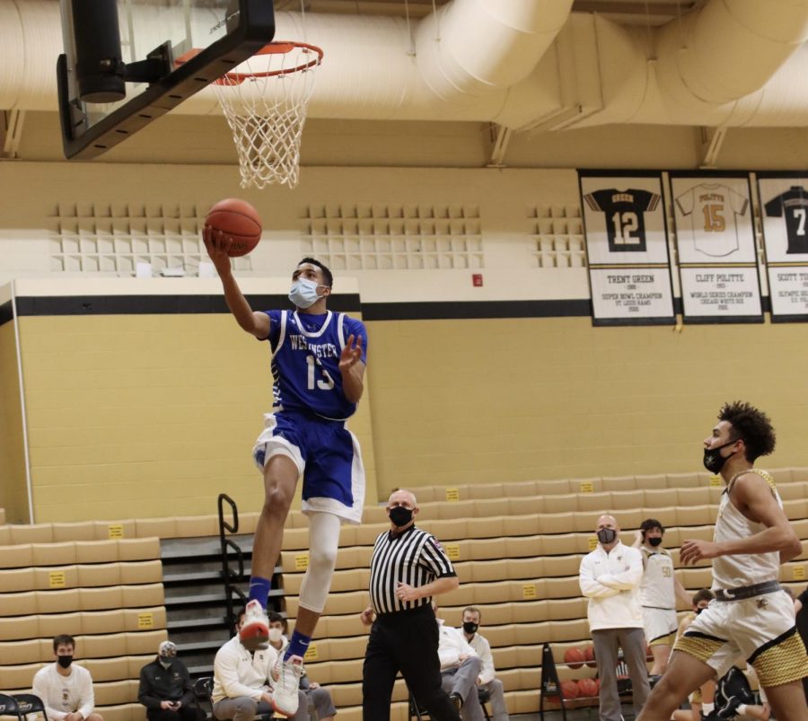 Caleb Thompson scoops in a layup in transition.