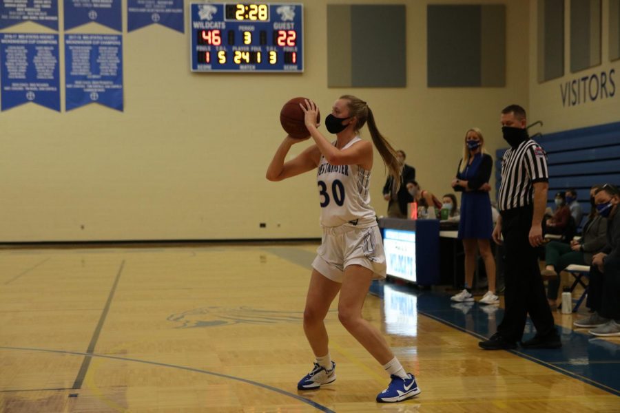 Carlie Vick shoots a three pointer against Cor Jesu.