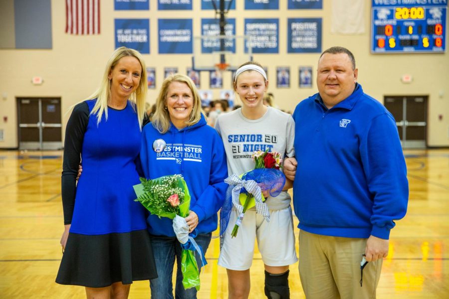 Marty Briner stands with her mother, Jennifer, father, Shawn, and coach, Kat Martin.