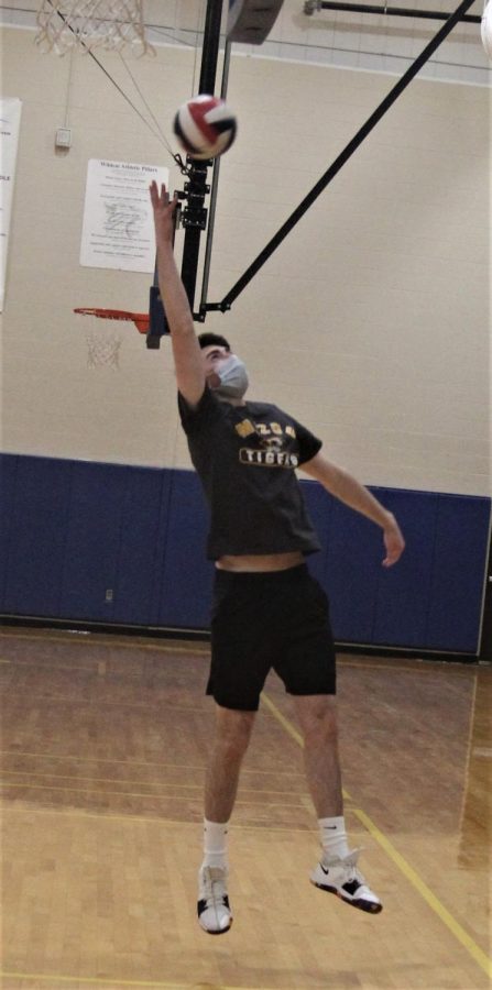 Braden White, senior,  warms up before practice.