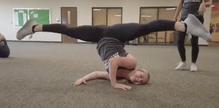 Kaitlyn Mann, Junior, doing a trick for one of their dances. She is one of the most energetic dancers on the team.