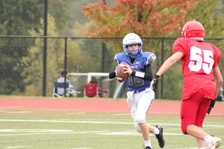 Owen Leingang rolls out of the pocket during the 8th grade football game.