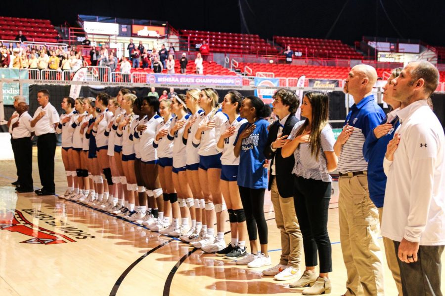 The+volleyball+team+lines+up+for+the+national+anthem+at+the+state+championship+game.