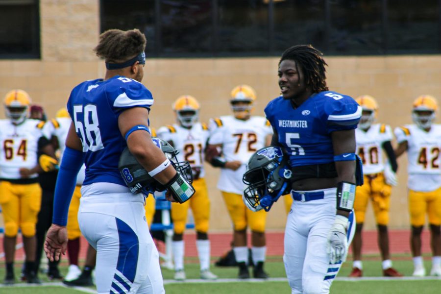 Lj Minner and Sterling Webb, seniors, go to center field for the coin toss against Lutheran North.