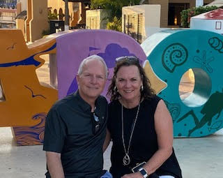 Mrs. DeRousse poses with her husband, they love each other deeply. 