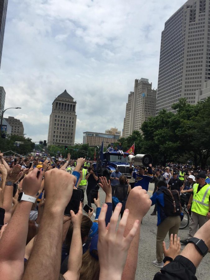 Over 500,000 fans cheer on the blues team as they roll by. 