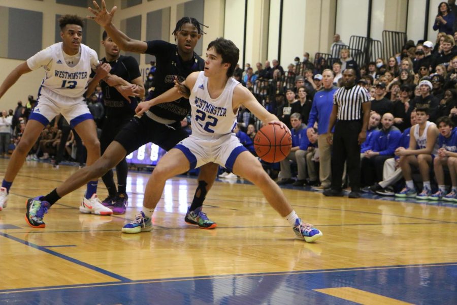 Casen Lawrence, senior, penetrates the baseline under heavy pressure before dishing out the ball. 