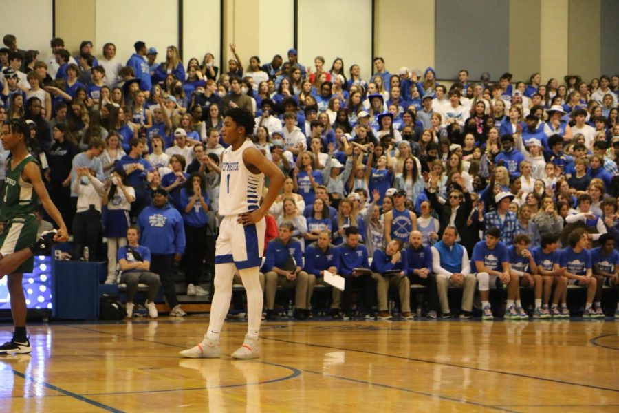 The entire student body gathers in the Blue Crew section to support the basketball team.