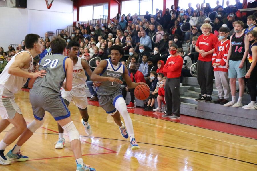 Kobi Williams drives to the hoop in front of the Chaminade student section.