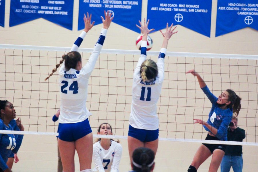 Emma Fairchild blocks the kill attempt, adding a point for the Wildcats.