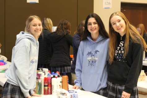 Three girls sort out items for ITSOG.