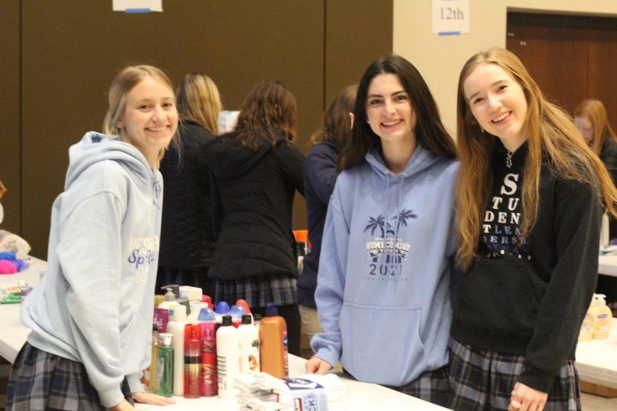 Three girls sort out items for ITSOG.