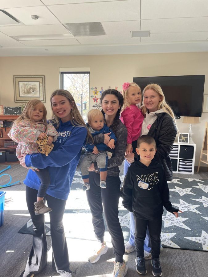 (L-R) Emma Ballew, Sabrina Holohan, and Molly Kate Bugh, juniors, hang out with health teacher and coach Dan Petke's kids.